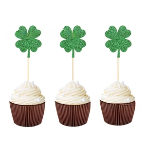 Gros plan de trois décorations de cupcakes trèfles verts pailletés pour la Saint-Patrick