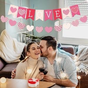 Valentine's Day banner set with LOVE letters and heart garlands in romantic party setting