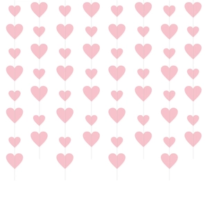 Vertical rows of pale pink paper hearts hanging for wedding and Valentine party decor