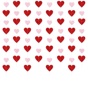 Macro view of glittering red and pink heart banners with sparkling glitter finish for parties