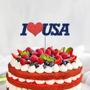 Close-up of glittery I Love USA cake topper on red velvet dessert with berries