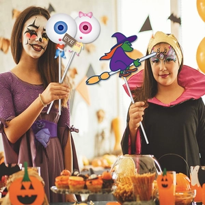 Close-up of Halloween photo props featuring eye and witch designs for parties
