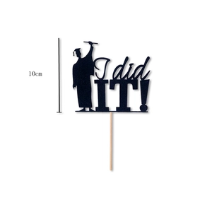 Detail showing 'I did IT!' black glitter graduation cake topper with silhouette, 10cm height