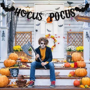 Detailed view of Hocus Pocus banner with glitter black letters, ghost and bats decor