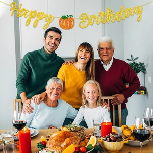 Glittery Happy Birthday banner with pumpkin decor for autumn theme party family celebration