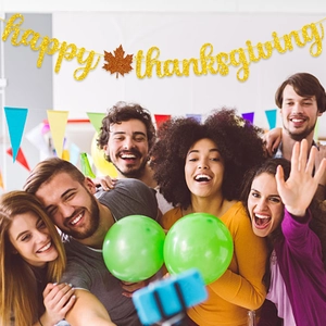 Glittering golden Happy Thanksgiving banner with orange maple leaf for festive party decor