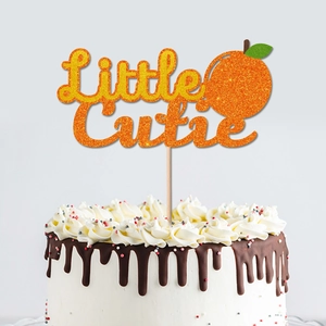 Glitter Little Cutie orange cake topper on white cake for a fruit theme birthday party