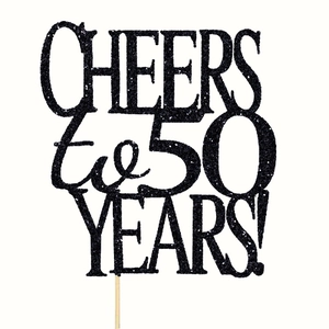 Detail of black glitter 'CHEERS to 50 YEARS!' cake topper with sparkles and wooden stick