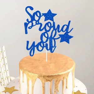 Blue glitter So Proud of You cake topper for graduation party decoration on a white cake