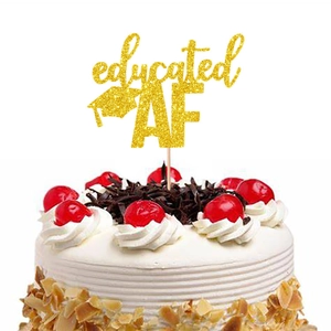 Glitter gold 'educated AF' graduation cake topper with doctoral cap on white cream cake
