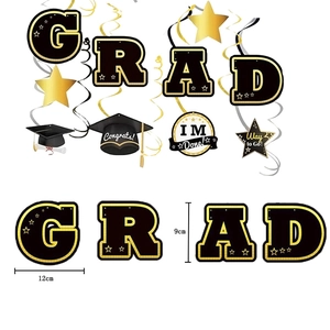 Graduation party decorations set with black and gold hanging spirals and grad theme signs