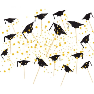 Close-up of 2026 graduation cap cake toppers with black glitter and gold stars