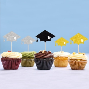 Glitter graduation cap cupcake toppers in black, gold, and silver on dessert
