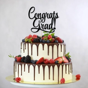 Black Congrats Grad cake topper on double-layer chocolate fruit cake for 2026 graduation party