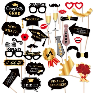 Black and gold graduation photo booth props set with mortarboard and trophy designs