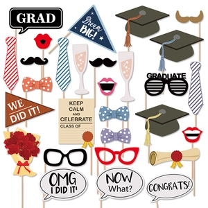Set of graduation photo booth props with academic caps and congratulatory signs on sticks