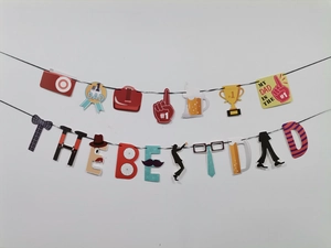 Dettaglio dello striscione Happy Father's Day con lettere Best Dad e decori festa
