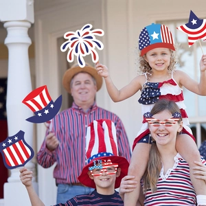 Family wearing patriotic 4th of July photo booth props with USA glasses and hats
