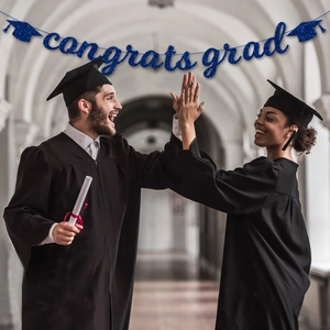 Blue glitter Congrats Grad banner with cap icons shown with graduates in background