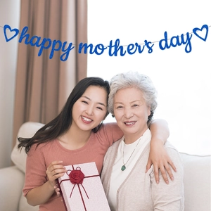 Blue glittery Happy Mother's Day banner held by mother and daughter at home