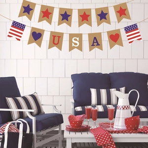 Detail of USA Independence Day bunting banner with stars and stripes over a patio setting