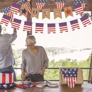 Independence Day party decorations set featuring USA letter banner and patriotic accessories