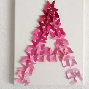 3D butterfly wall art featuring a red and pink gradient letter A on white canvas