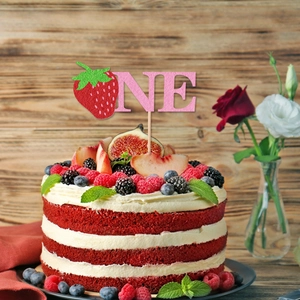 Pink glitter ONE strawberry cake topper for first birthday celebration on a velvet cake