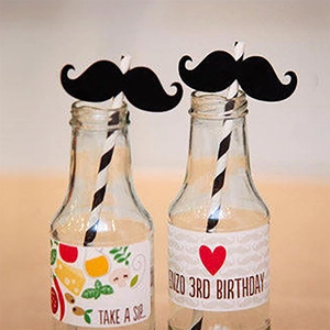 Detail of black moustache straw toppers for birthday party cake and drink decoration
