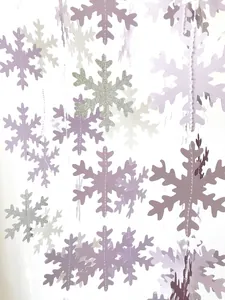 Detailed view of hanging 3D snowflake garlands in purple and white for holiday decor