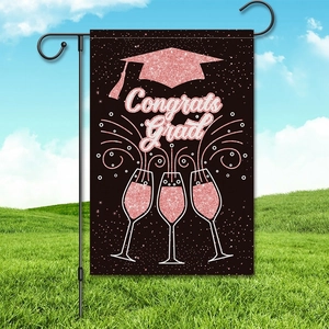 Graduation garden flag with Congrats Grad text, black bachelor cap, and metal stand