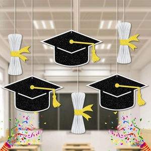 Graduation party decorations featuring glitter mortarboards and honeycomb diploma charms