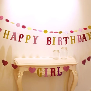 Close-up of pink and gold glitter Happy Birthday Girl banner and heart party decorations