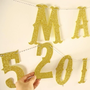 Detail of glitter gold letters and numbers banner for wedding and birthday party decor