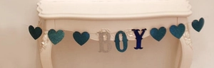 Detail of glittery blue BOY banner with hearts for baby shower party decorations