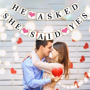 Wedding banner decoration with He Asked and She Said Yes text and pink heart design