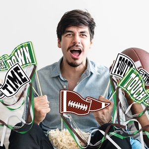 American football party photo props with team spirit streamers and touchdown signs