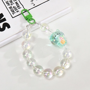 Detail of green acrylic cat charm and iridescent beads on a mobile phone chain strap