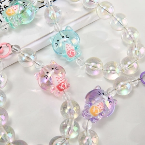 Detailed macro view of colorful acrylic beads and cute cat charms for phone case chain