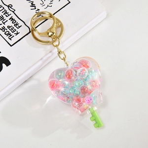Creative heart-shaped oil-filled quicksand bottle keychain with blue and pink glitters