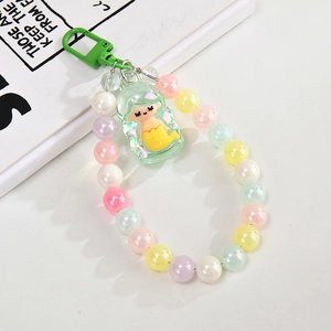 Detailed view of beaded mermaid phone chain with iridescent macaron pearls and green clasp