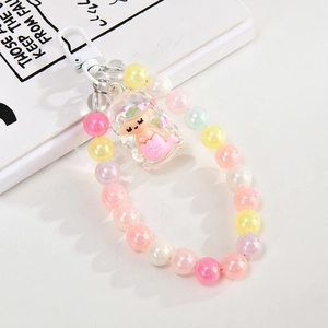 Detailed view of a cute mermaid bead charm with iridescent pearls and acrylic pendant