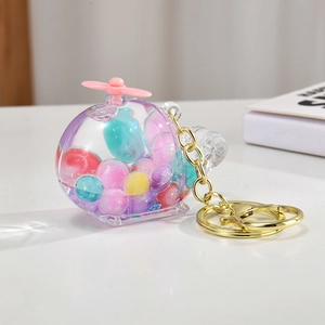 Detailed macro view of the colorful glitter balls inside the clear acrylic helicopter keychain