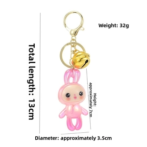 Pink acrylic bunny keychain with golden bell and dimensions showing total length 13cm