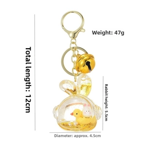 Detailed view of 12cm rabbit oil keychain with yellow duck and golden glitter sand