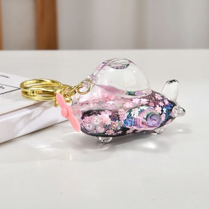 Glittery airplane liquid keychain with cherry blossom sequins and white pearls