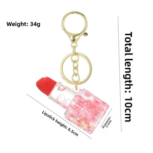 Vue détaillée du porte-clés rouge à lèvres montrant la longueur de 10cm et le poids de 34g
