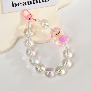 Detail of iridescent acrylic bead phone strap with a purple cartoon girl charm