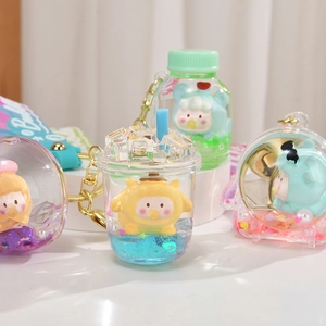 Cute acrylic liquid quicksand keychain with miniature figures and blue PVC strap