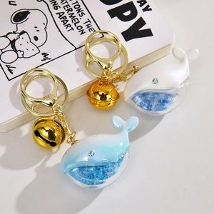 Acrylic liquid quicksand whale keychain with gold clasp and glitter for backpack